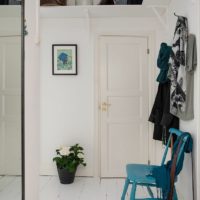 White hallway and blue highchair