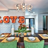 Red letters with bulbs in the living room interior