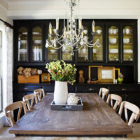 Chandelier with candles over a wooden table in retro style