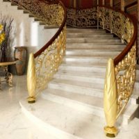 Staircase with golden railing in a private house