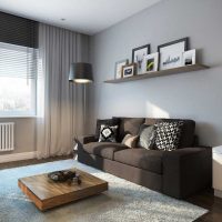 Wall decoration over the sofa with paintings and photographs