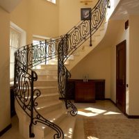 Staircase with forged railing in the corridor of a country house