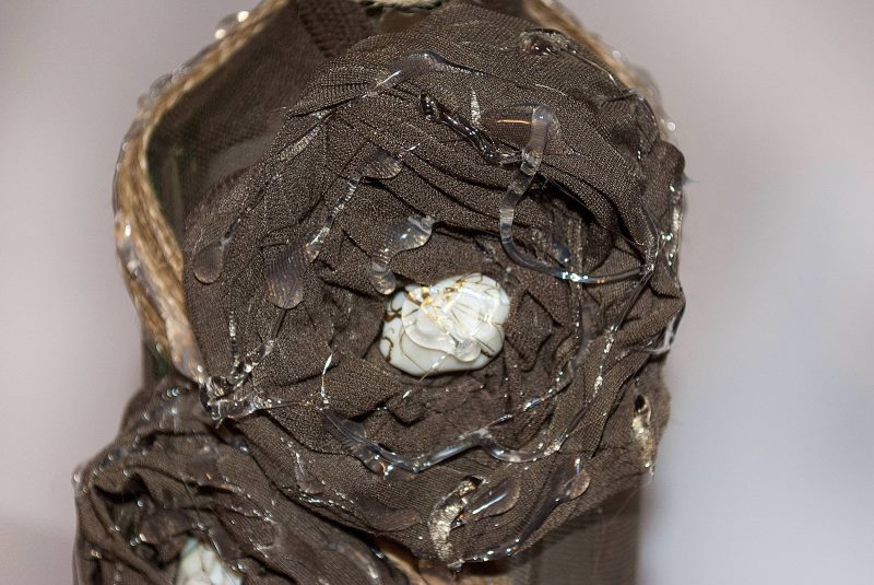 Putting hot glue on a pantyhose bottle