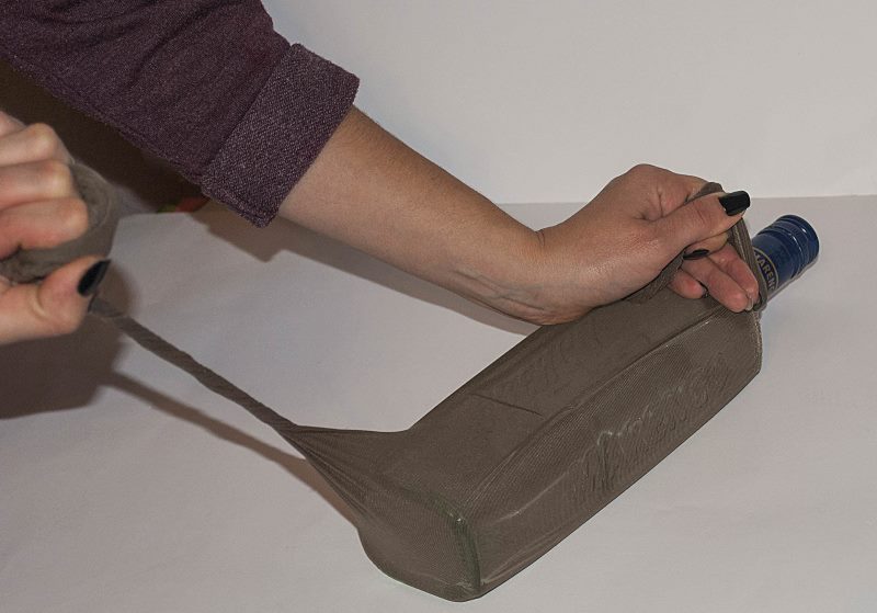 The process of decorating a bottle with nylon tights