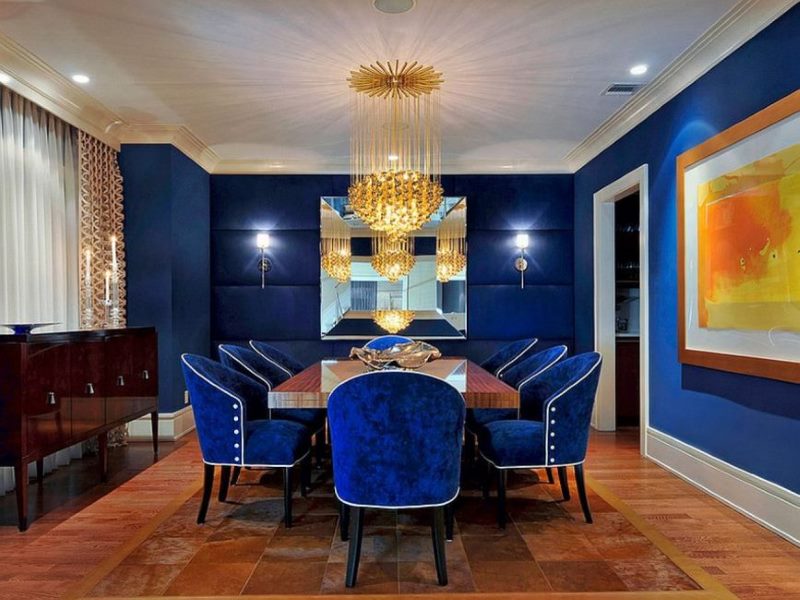 Upholstered chairs with blue upholstery in the dining area of the living room